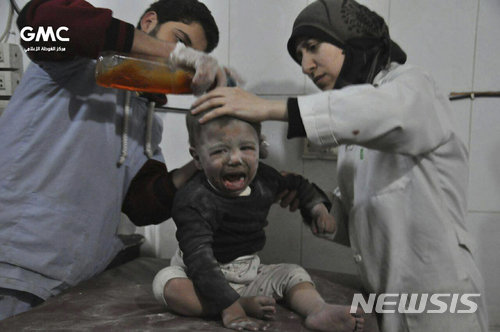 21일(현지시간) 시리아 구타의 한 임시 병원에서 의료진이 공습으로 다친 어린이를 치료하고 있다. (출처: 뉴시스)