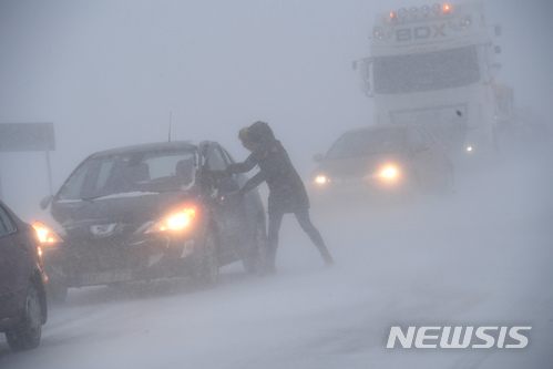 【스외보=AP/뉴시스】노르웨이 스웨보 인근에서 27일(현지시간) 한 여성이 눈보라가 몰아치는 거리에서 자동차에 타려 하고 있다. 시베리아 찬 공기가 유럽 대부분 지역을 강타하면서 이날 기온이 급강하하고 폭설이 내렸다. 2018.2.28