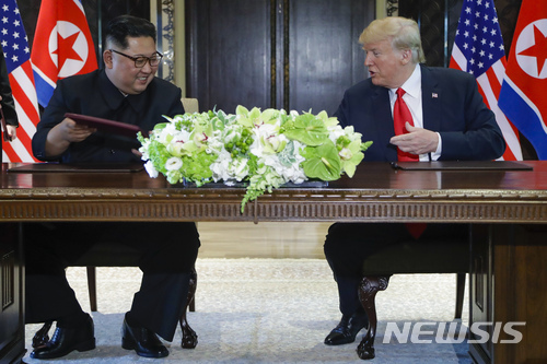 북한 김정은 국무위원장과 미국 도널드 트럼프 대통령이 12일 오후 1시35분(현지시간)께 싱가포르 센토사섬 카펠라호텔에서 합의문에 서명했다. (출처: 뉴시스)