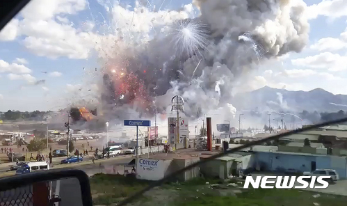 【툴테펙=AP/뉴시스】멕시코 툴테펙의 폭죽시장에서 지난해 12월 20일(현지시간) 폭발사고가 발생해 불꽃과 연기가 치솟고 있다. 사진은 동영상 화면을 캡처한 것.