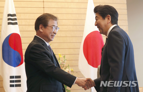 아베 신조 일본 총리(오른쪽)가 지난 3월 13일 도쿄에서 서훈 국정원장을 만나 악수를 하고 있는 모습 (출처: 뉴시스)