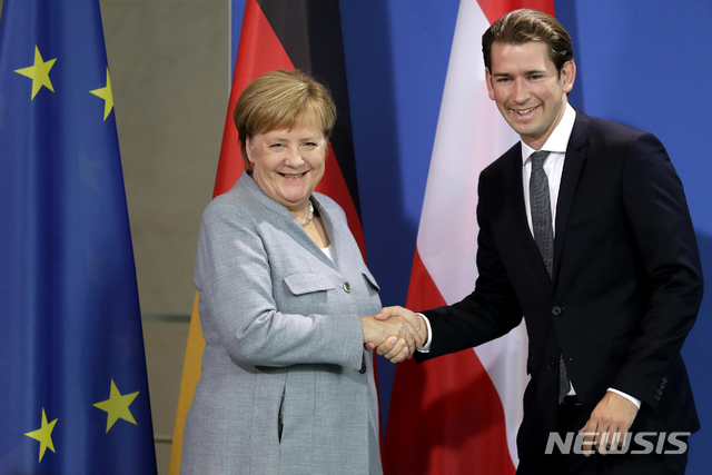【베를린= AP/뉴시스】 앙겔라 메르켈 독일 총리가 16일(현지시간) 베를린을 방문한 제바스티안 쿠르츠 오스트리아 총리와 만난 뒤 공동기자회견 직전에 악수를 나누고 있다. 