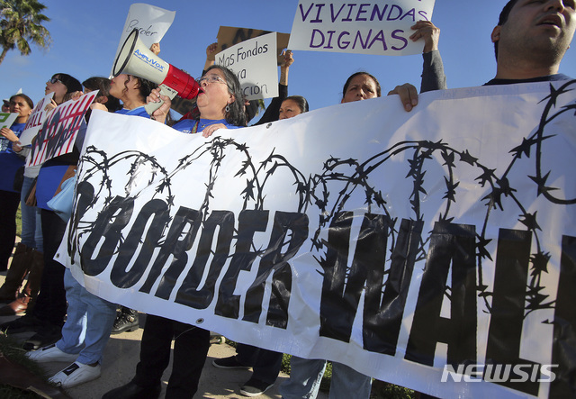 도널드 트럼프 미국 대통령이 10일(현지시간) 미 텍사스주 멕시코 국경 지역을 살피기 위해 매캘런에 도착한 가운데 공항에 모인 장벽을 반대하는 사람들이 시위를 벌이고 있다.  (출처: 뉴시스)