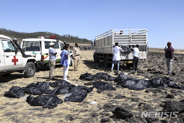 10일(현지시간) 에티오피아 수도 아디스아바바 남동쪽 60km가량 떨어진 비쇼프투 마을 부근 항공기 추락 현장에서 구조대원들이 희생자 시신을 수습하고 있다.   승객과 승무원 157명을 태우고 에티오피아를 떠나 케냐 나이로비로 향하던 에티오피아 항공 보잉 '737-800 맥스' 여객기가 추락해 157명이 전원이 숨졌다고 항공사가 밝혔다. (출처: 뉴시스)