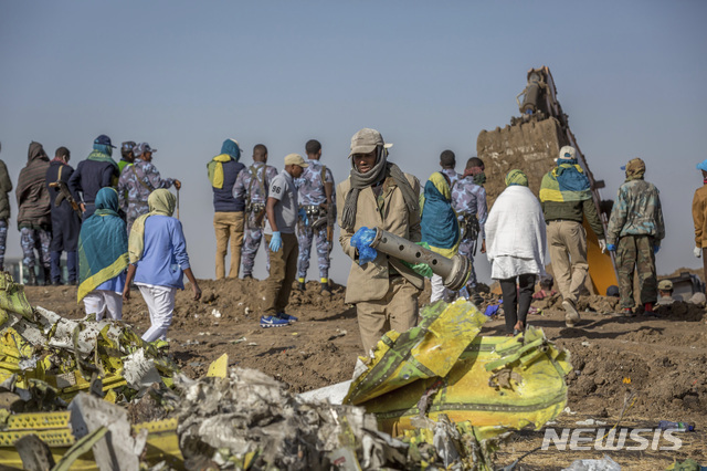 11일(현지시간) 에티오피아 수도 아디스아바바 남동쪽 60km가량 떨어진 비쇼프투 마을 항공기 추락 현장에서 관계자들이 사고기 잔해를 조사하고 있다. 에티오피아 항공 측은 탑승자 157명이 사망한 보잉 737 맥스 8기의 추락과 관련해 사전 예방 차원에서 모든 동종 항공기의 이륙을 금지했다고 대변인이 밝혔다. (출처: 뉴시스)