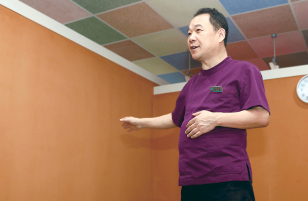 김지환 원장이 양자 보드와 벽면과 바닥을 황토로 시공해 환자의 건강 회복을 돕고 냄새를 잡아주고 있다고 설명하고 있는 모습. ⓒ천지일보 2019.3.20