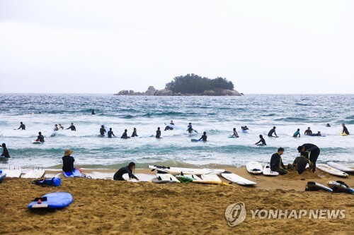 (양양=연합뉴스) 궂은 날씨에도 주말을 맞아 서핑을 즐기러 찾아온 서퍼들로 20일 양양 기사문 해변이 붐비고 있다.