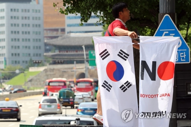 6일 오전 서울 중구 시청 인근에서 중구청 관계자가 일본이 백색국가(화이트리스트)에서 한국을 제외한 것에 대한 항의의 뜻으로 '노(보이콧) 재팬' : 가지 않습니다 사지 않습니다'라고 적힌 배너기를 설치하고 있다. (출처: 연합뉴스)