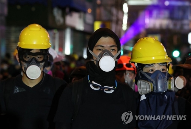 17일 오후(현지시간) 홍콩 카오룽반도 몽콕경찰서 앞에서 시위대가 경찰의 최루탄 진압에 대비해 방독면을 쓰고 있다. (출처: 연합뉴스)