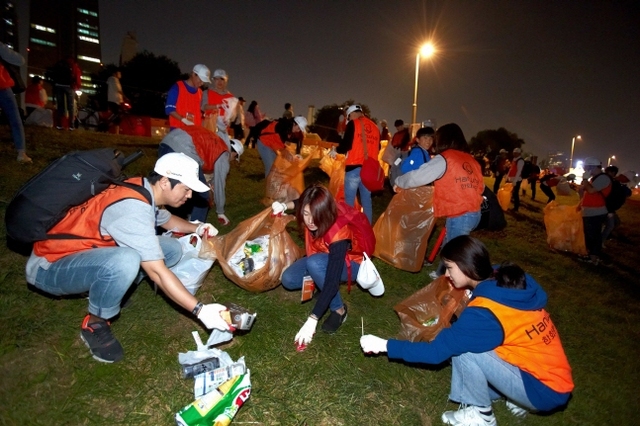 ㈜한화는 5일 열리는 ‘한화와 함께하는 서울세계불꽃축제 2019’에서 안전하고 즐거운 축제관람을 위한 ‘클린캠페인’을 진행한다. 사진은 지난해 행사에서 한화 임직원을 포함한 시민자원봉사자들이 쓰레기를 수거하며 환경정화활동을 펼치는 모습. (제공: ㈜한화)
