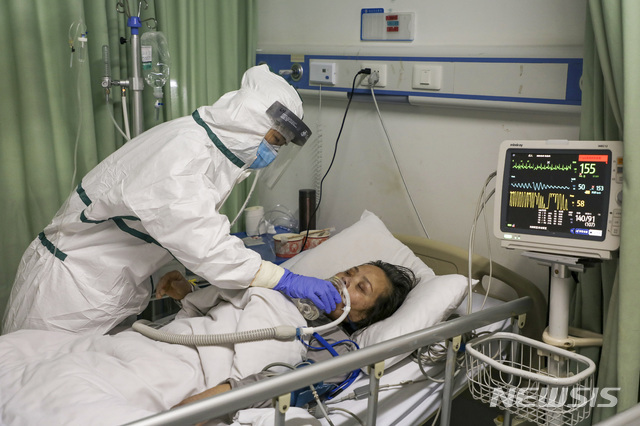 중국 후베이성 우한의 한 병원에서 6일 보호복을 입은 간호사가 코로나 19 환자를 돌보고 있다. (출처: 뉴시스)