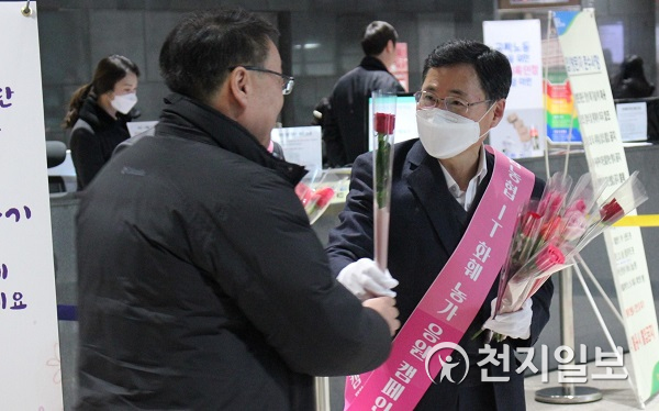 19일 경기 의왕시 NH통합IT센터에서 김현우 IT전략본부장(오른쪽)이 출근하는 임직원들에게 꽃을 나눠 주고 있다. (제공: 농협) ⓒ천지일보 2020.2.19