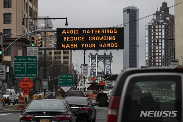 19일(현지시간) 미국 뉴욕 브루클린 지역 도로의 전광판에 신종 코로나바이러스 감염증(코로나19) 확산을 막기 위해 모임을 피하고 손을 씻으라는 안내가 나오고 있다. (출처: 뉴시스)