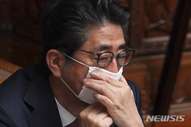 신종 코로나바이러스 감염증 예방을 위해 마스크를 쓴 아베 신조 일본 총리가 3일 일본 도쿄에서 열린 국회 상원 본회의에 참석해 마스크를 매만지고 있다. (출처: 뉴시스)