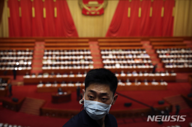 중국 베이징 인민대회당에서 22일 마스크를 최대 정치 행사 전국인민대표대회(전인대) 개막식이 열리고 있는 가운데 마스크를 쓴 한 남성이 서있다. (출처: 뉴시스)