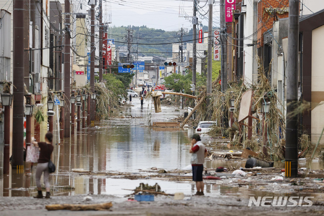 일본 규슈 구마모토현 일대에 최대 시간당 100mm 가까운 폭우가 쏟아지면서 홍수와 침수 등으로 적어도 16명이 숨진 가운데 초토화한 히토요시 시내에서 4일 시민들이 가재도구와 물건들을 정리하고 있다. (AP/뉴시스)