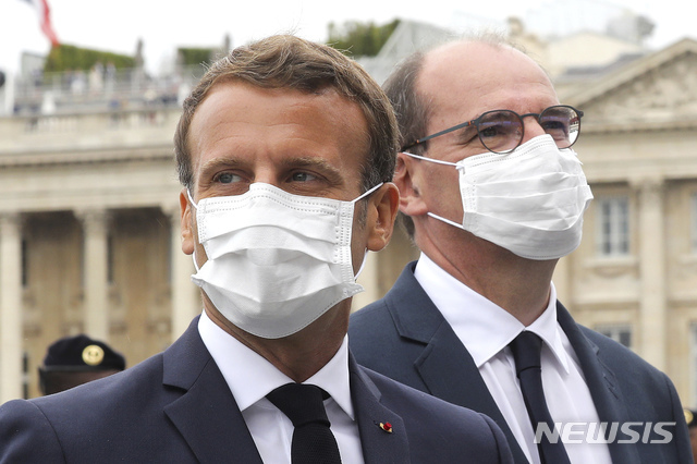 14일(현지시간) 에마뉘엘 마크롱 프랑스 대통령(왼쪽)과 장 카스텍스 총리가 마스크를 착용한 채 파리에서 진행된 프랑스 대혁명 기념일 행사에 참여하고 있다. (출처: 파리=AP/뉴시스)