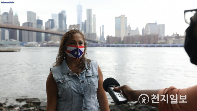 25일(현지시간) 미국 뉴욕 브루클린 브리지에서 한 시민이 한국 정부의 코로나19 조치에 대해 답하고 있다. ⓒ천지일보 2020.7.27
