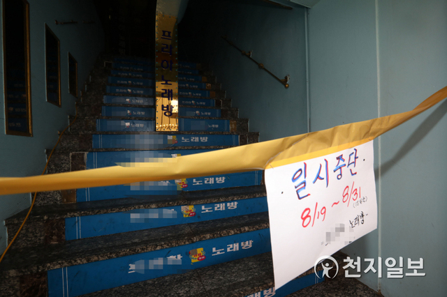 [천지일보=남승우 기자] 코로나19 재확산으로 정부의 사회적 거리두기 2단계 강화조치가 시행된 19일 서울 종로구 종각 젊음의 거리의 한 노래방에 영업중단 안내문이 걸려 있다. ⓒ천지일보 2020.8.19
