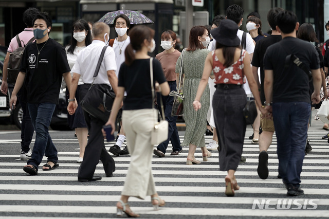 [도쿄=AP/뉴시스] 일본 수도 도쿄 쇼핑가에서 10일 시민들이 코로나19 예방을 위해 마스크를 착용한 채 바삐 움직이고 있다.