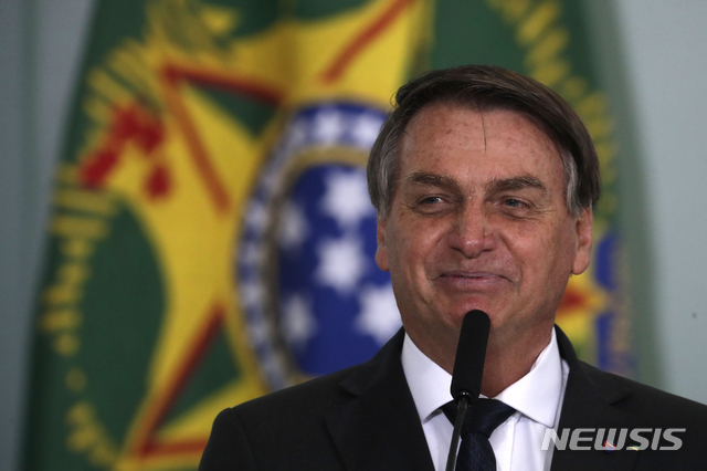 [브라질리아=AP/뉴시스] 자이르 보우소나루 브라질 대통령이 8월 25일(현지시간) 브라질리아의 대통령궁에서 '그린 & 옐로 하우스' 주택 프로그램 출범식에 참석해 연설하며 미소짓고 있다.