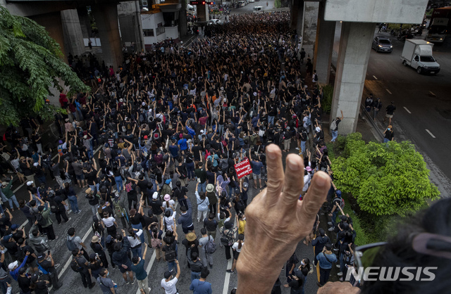 10월 7일 태국 방콕 근교에서 열린 시위에서 한 반정부 시위자가 손가락 세 개로 경례하는 손짓을 하고 있다. 태국 헌재는 쁘라윳 짠오차 태국 총리가 전역 후에도 군 관사를 사용한 것이 위헌이라는 야당의 주장을 기각하면서 총리직을 유지하게 됐다. (출처: 뉴시스/AP)