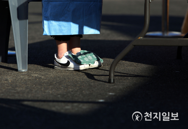 [천지일보=남승우 기자] 신종 코로나바이러스 감염증(코로나19) 신규 확진자가 1241명으로 집계된 25일 오전 서울역 광장에 마련된 임시 선별검사소에서 의료진이 신발 위에 핫팩을 올린 채 발을 녹이고 있다. ⓒ천지일보 2020.12.25