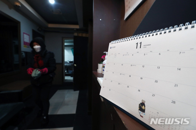 집합금지 제외 대상에 포함되지 못한 유흥시설 업주들이 21일 오후 서울 시내의 업소에서 실내와 간판에 불을 켜는 '점등 시위'를 하고 있다. 지난해 11월 23일 이후로 문을 열지 못한 업소의 달력은 11월에 멈춰 있다. (출처: 뉴시스)