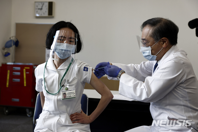코로나19 백신 선행 접종하는 일본 의료인[도쿄=AP/뉴시스] 17일 일본 도쿄의 도쿄 의료센터에서 한 의료인이 코로나19 백신을 접종하고 있다. 일본은 17일 백신의 안정성 확인을 위해 4만여 명의 의료계 종사자를 선행 대상으로 코로나19 백신 접종을 시작했다.
