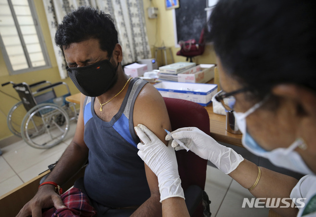 [벵갈루루=AP/뉴시스] 1일(현지시간) 인도 벵갈루루의 한 국립병원에서 코백스 백신을 접종하는 한 남성이 얼굴을 찡그리고 있다. 인도 정부는 45세 이상 모든 사람에게 백신 접종을 시행해 백신 접종에 박차를 가하고 있다.