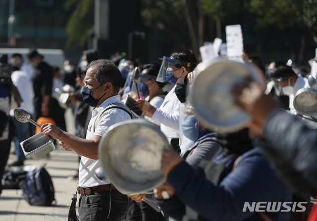[멕시코시티=AP/뉴시스]4일(현지시간) 멕시코 수도 멕시코시티에서 식당 종사자들이 금속 식기를 두드리며 코로나19 '적색경보' 항의 시위를 벌이고 있다.