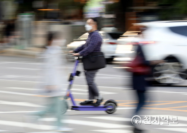[천지일보=남승우 기자] 전동킥보드 등 개인형 이동장치(PM) 운전자의 안전을 강화한 개정 도로교통법 시행을 하루 앞둔 12일 오후 서울 마포구 공덕오거리에서 한 시민이 헬멧을 착용하지 않은 채 킥보드를 타고 있다. ⓒ천지일보 2021.5.12