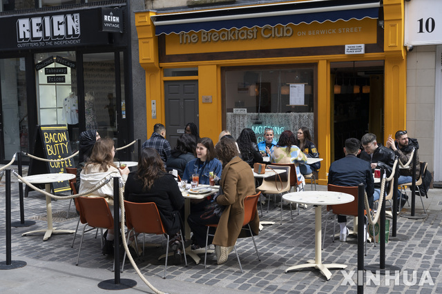 지난 12일 영국 런던 소호에 있는 야외 식당에서 시민들이 식사를 하고 있다. 이날부터 영국에서는 봉쇄가 완화돼 식당, 미용실, 상점 등이 문을 다시 열었다. (출처: 뉴시스)