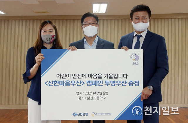 지난 6일 서울 남산초등학교에서 안준식 신한은행 부행장(가운데)와 김경미 남산초등학교장(왼쪽), 정영균 한국어린이안전재단 사무총장이 기념촬영을 하고 있다. (제공: 신한은행) ⓒ천지일보 2021.7.8