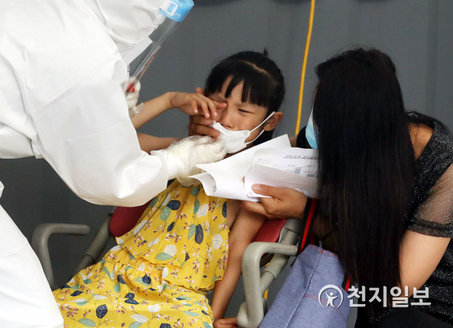 [천지일보=남승우 기자] 신종 코로나바이러스 감염증(코로나19) 신규 확진자가 1324명으로 집계된 11일 서울역 광장에 마련된 임시 선별검사소에서 한 아이가 코로나19 검사를 받던 중 눈물을 흘리고 있다. ⓒ천지일보 2021.7.11
