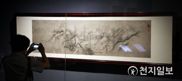 [천지일보=남승우 기자] 20일 서울 용산구 국립중앙박물관 상설전시관에서 열린 위대한 문화유산을 함께 누리다 ‘고 이건희 회장 기증 명품전’ 언론공개회에서 한 참석자가 단원 김홍도의 ‘추성부도’ 작품을 살펴보고 있다.이번 전시는 국립중앙박물관에서 오는 9월 26일까지 개최하며 이건희 회장 기증품 중 시대와 분야를 대표하는 명품 45건 77점(국보·보물 28건 포함)을 선보일 예정이다. ⓒ천지일보 2021.7.20
