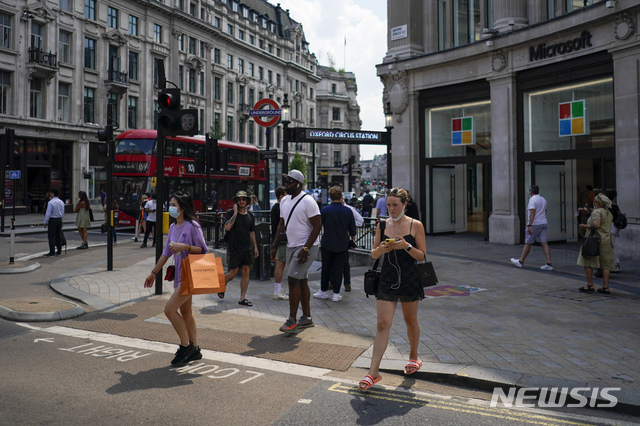 [런던=AP/뉴시스] 영국의 코로나19 규제가 완전히 해제된 19일(현지시간) 런던의 옥스퍼드 광장에서 대부분 마스크를 쓰지 않은 시민들이 걷고 있다.
