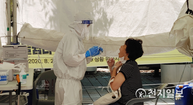 [천지일보 부산=윤선영 기자] 지난 27일 부산 시청 인근에 있는 등대광장 임시선별검사소에서 한 시민이 코로나 검사를 받고 있다. ⓒ천지일보 2021.8.29