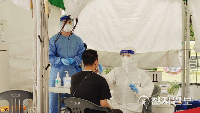 [천지일보 부산=윤선영 기자] 부산시청 인근에 있는 등대광장 임시선별검사소에서 한 시민이 신종 코로나바이러스 감염증(코로나19) 검사를 받기 위해 검체를 채취하고 있다. ⓒ천지일보 2021.10.15