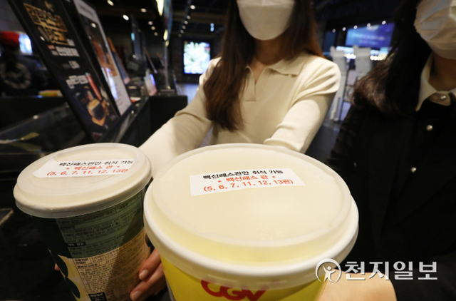 [천지일보=남승우 기자] ‘단계적 일상회복(위드 코로나)’ 1단계 시행 첫날인 1일 오후 서울 시내의 한 영화관에서 관람객들이 구매한 팝콘통에 ‘백신패스관만 취식 가능’이라는 문구가 적힌 스티커가 붙어 있다.  ⓒ천지일보 2021.11.1