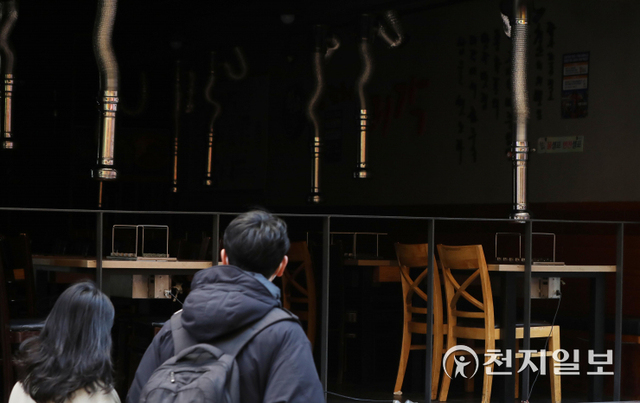 [천지일보=남승우 기자] 3일 오후 서울 종로구의 한 먹자골목 내 한 매장에 불이 꺼진 채 테이블이 텅 비어 있다. 신종 코로나바이러스 감염증(코로나19) 확산세가 좀처럼 잡히지 않자 정부가 오는 6일부터 사적모임 인원제한을 수도권 최대 6명, 비수도권 8명까지로 축소하기로 했다. 위드 코로나 개시 후 약 한 달 만이다. 아울러 그동안 방역패스(접종증명·음성확인제)가 적용이 되지 않았던 식당과 카페에 대해서도 방역패스가 작용된다.  ⓒ천지일보 2021.12.3