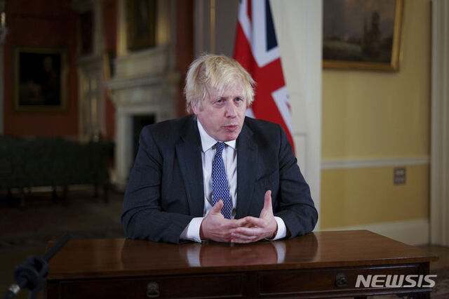 [런던=AP/뉴시스] 보리스 존슨 영국 총리가 12일(현지시간) 런던 다우닝가에서 대국민 연설을 하고 있다. 존슨 총리는 영국이 오미크론 변이의 파도에 직면해 있다며 비상사태를 선포하고, 오미크론 변이에 대한 방어 강화를 위해 모든 18세 이상 국민에 대한 부스터 샷 접종을 올해 안에 끝내겠다고 밝혔다.