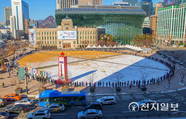 [천지일보=박준성 기자] 코로나19 오미크론 변이가 급속히 확산하며 역대 최다인 2만명이 넘는 신규 확진자를 기록한 2일 서울 중구 서울시청 광장에 마련된 임시선별검사소에서 시민들이 줄을 서서 검사 순서를 기다리고 있다. 중앙방역대책본부는 설 연휴 닷새째이자 마지막 날인 이날 0시 기준으로 확진자가 2만 270명 늘어 누적 88만 4310명이라고 밝혔다. ⓒ천지일보 2022.2.2