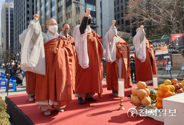 [천지일보=황해연 기자] 대한불교조계종 사회노동위원회와 코로나19 백신 피해자 가족협의회(코백회)가 12일 서울 종로구 청계광장에서 개최한 ‘신종 코로나바이러스 감염증(코로나19) 백신 희생자 추모 및 진상규명과 피해자 대책마련 촉구 기도회’를 개최한 가운데 스님들이 구호를 외치고 있다. ⓒ천지일보 2022.2.12