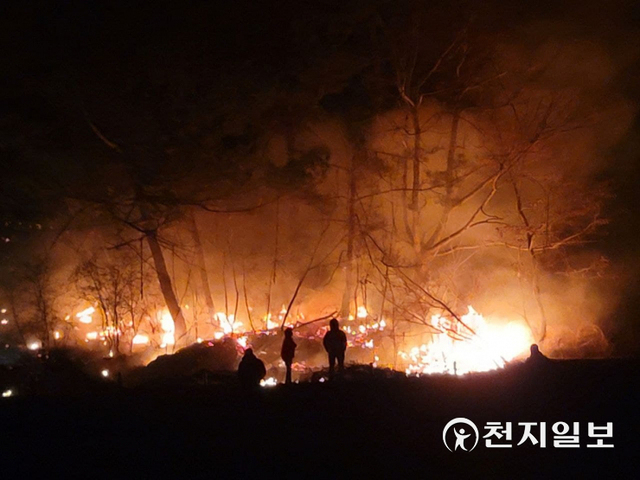 [천지일보 울진=송해인 기자] 경북 울진 산불이 확산 중인 지난 5일 산불이 울진 소재 한 야산을 불태우고 있는 가운데 소방관계자들이 현장을 지켜보고 있다. ⓒ천지일보 2022.3.8