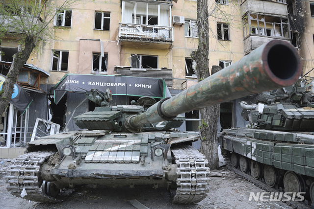 [마리우폴=AP/뉴시스] 4일(현지시간) 우크라이나 마리우폴의 파손된 아파트 부근에서 도네츠크인민공화국(DPR)군의 전차들이 대기하고 있다.