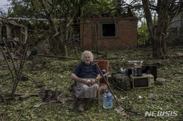 5일(현지시간) 우크라이나 동부 드루즈키우카에서 옐레나 홀로우코가 미사일 공격으로 파손된 자신의 집 잔해들 사이에 앉아 있다. (출처: 뉴시스)
