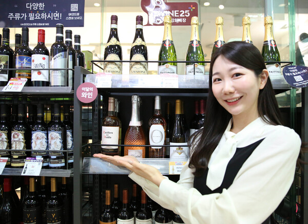 모델이 GS25의 로제와인 진열 매대 앞에서 와인을 소개하고 있다. (제공: GS리테일)