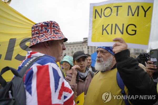 영국 찰스 3세 국왕 대관식이 열린 6일(현지시간) 런던 시내에서 반군주제 시위 참가자가 '내 국왕이 아니다'라는 팻말을 들고 있다. (AP=연합뉴스)
