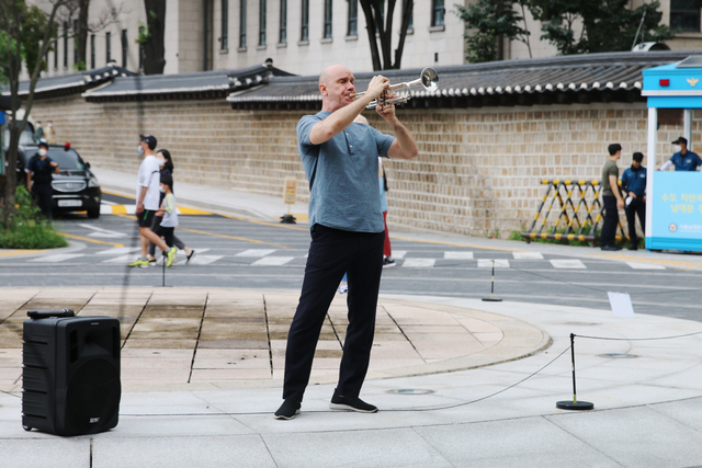 A Ukrainian plays the trumpet as wishing for peace and cessation of war in front of Jeong-dong Fountain in Jung-gu, Seoul on July 24. ⓒCheonji Daily News  2022.07.24.